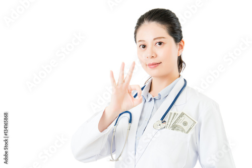 asian woman doctor take money bribery with ok gesture