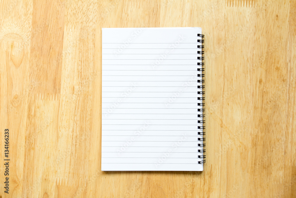 Blank paper note book on wood table background Blank paper note book on wood table background