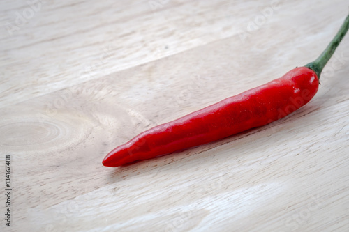 Fresh red chilli on wooden chopping board. selective focus.