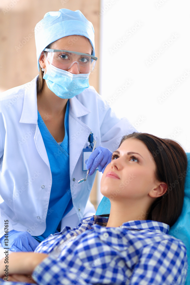 Woman dentist working at her patients teeth Woman dentist working at her patients teeth