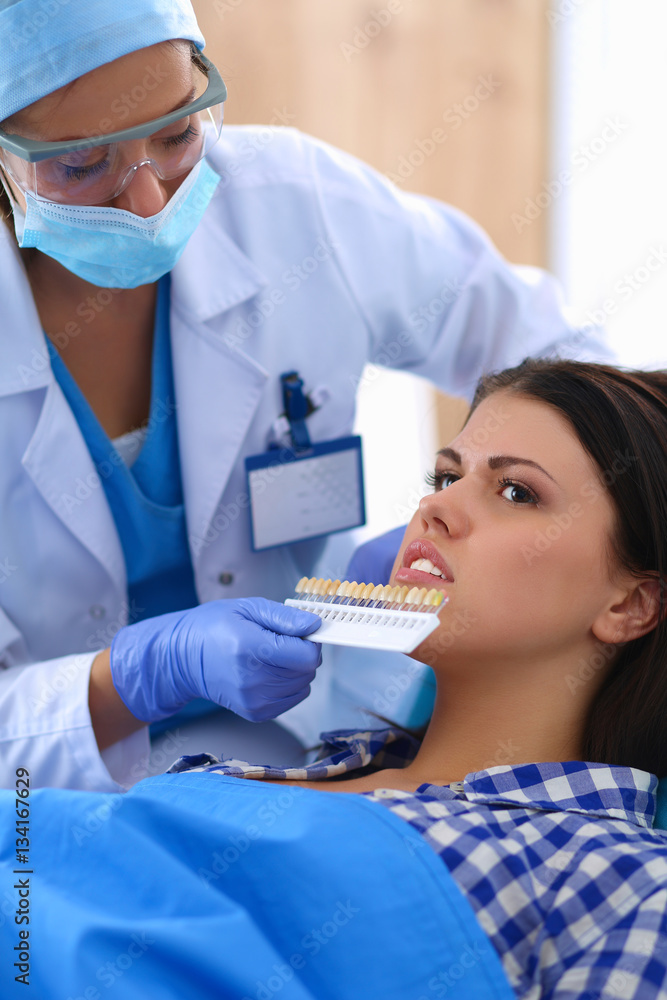 Woman dentist working at her patients teeth Woman dentist working at her patients teeth