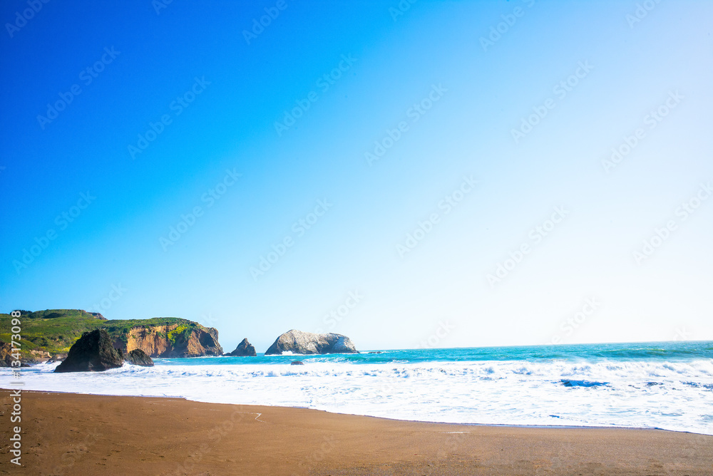 Waves on Rodeo Beach Cove in the Marin Headlands, just north of San Francisco, California, USA. Blue sky on a sunny day. Waves on Rodeo Beach Cove in the Marin Headlands, just north of San Francisco, California, USA. Blue sky on a sunny day.