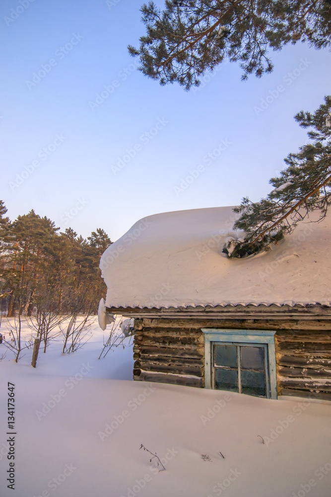 vertical background with abandoned cabin covered by snow under o