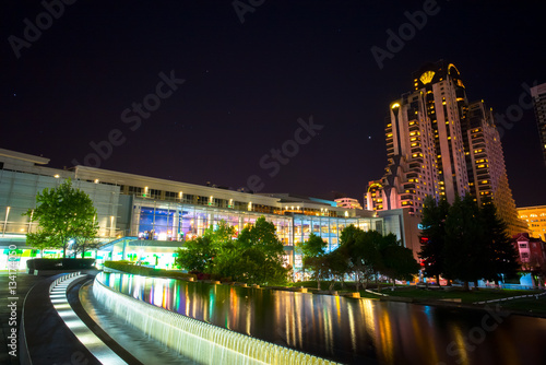 Buildings in San Francisco at night.  Reflections on the water in a pool.