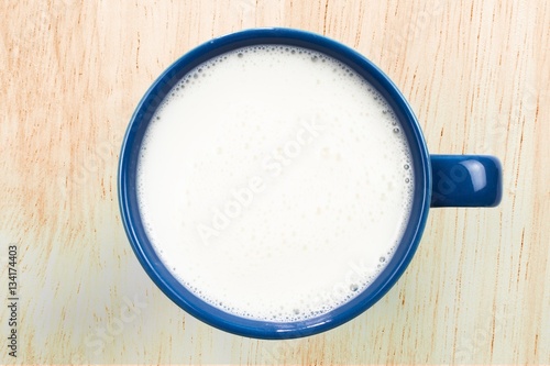 top view of glass milk / Glass of Milk From Above on wood background