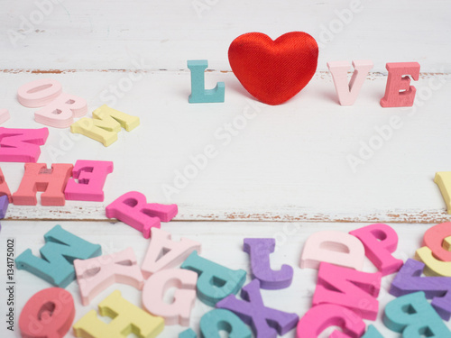 Vanlentine's day concept. Wooden letters word love and red heart and car vintage on color background with copy space.