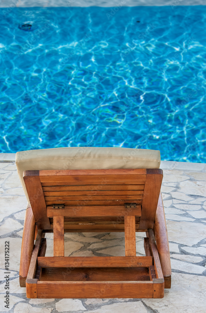fauteuil de plage en bordure de piscine 
