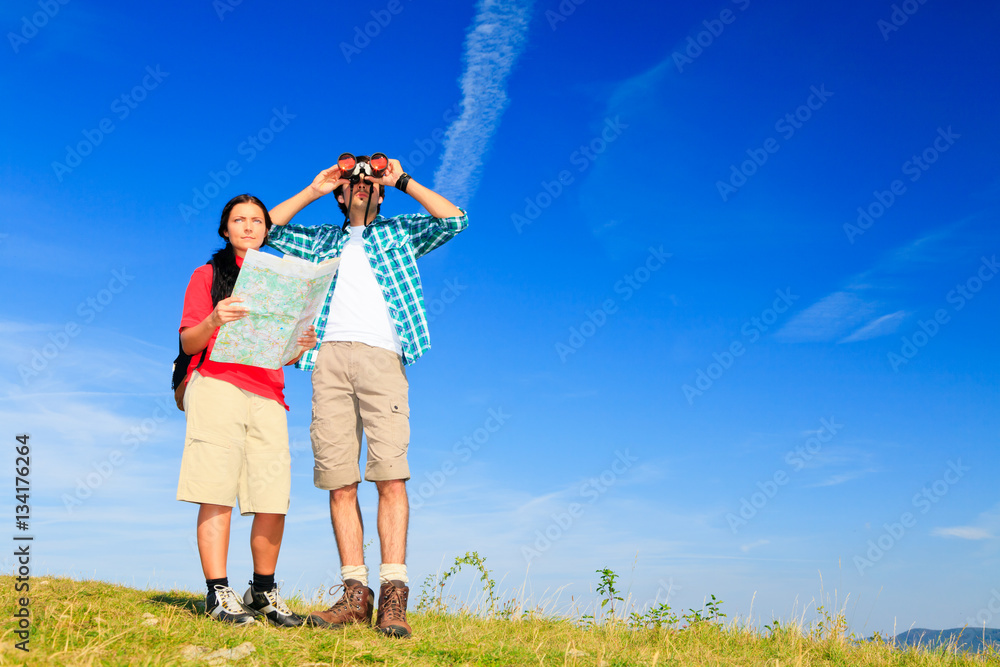 Young Couple Standing At The Top Of A Hill