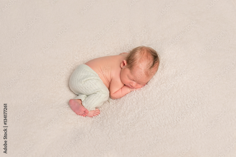 Child on a blanket, napping, topview Child on a blanket, napping, topview