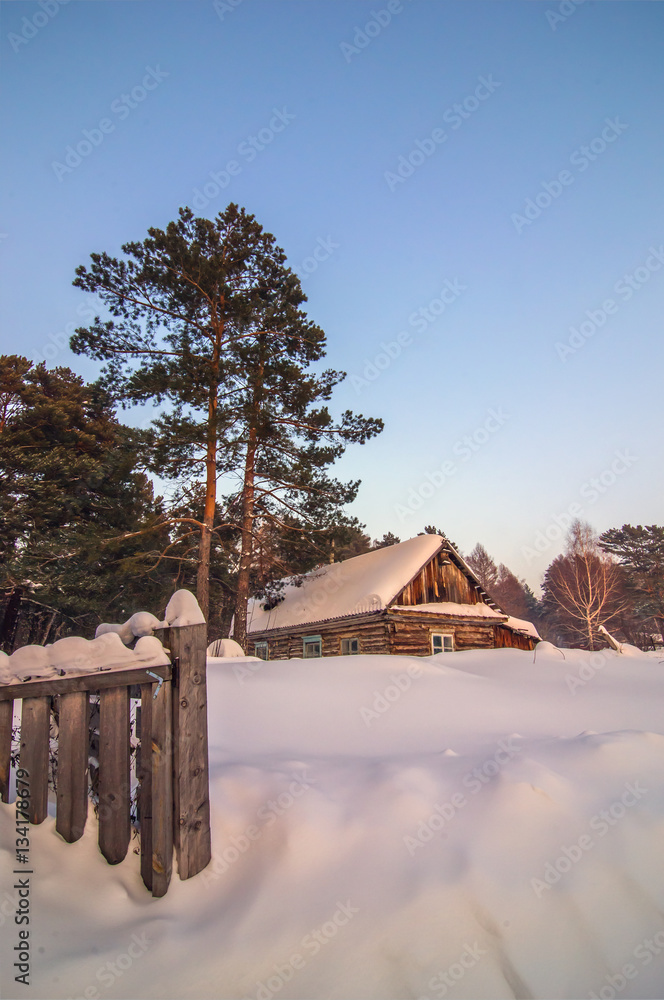 vertical background with abandoned cabin covered by snow under o