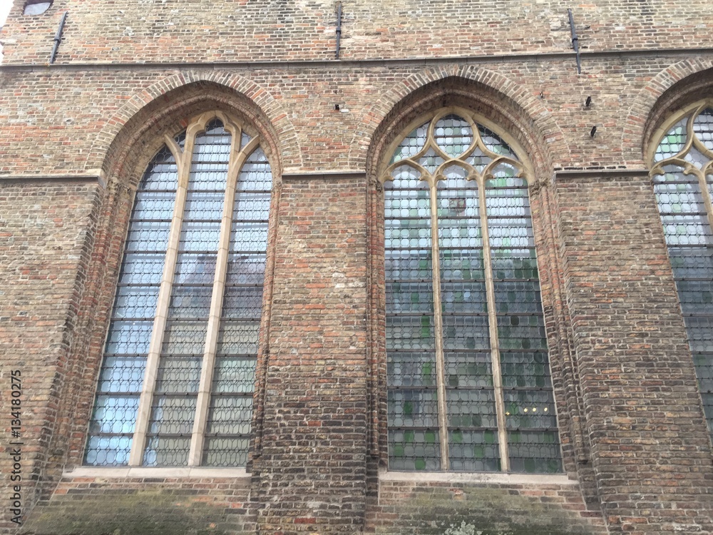 Church windows and brick block wall