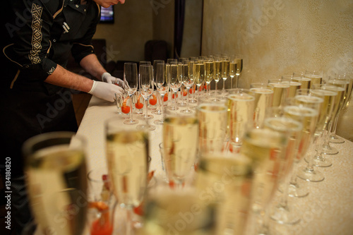 Catering service, bartender and glasses with wine and champagne