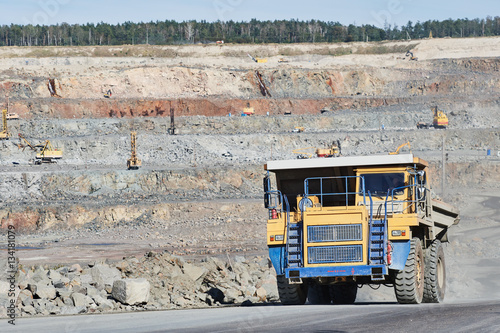 Huge dump truck transporting granite rock or iron ore photo