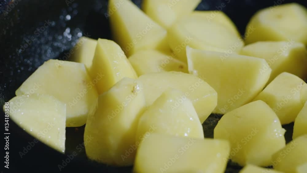 Cooking potatoes. Pieces of food fried in oil. Tasty, but not healthy food Cooking potatoes. Pieces of food fried in oil. Tasty, but not healthy food