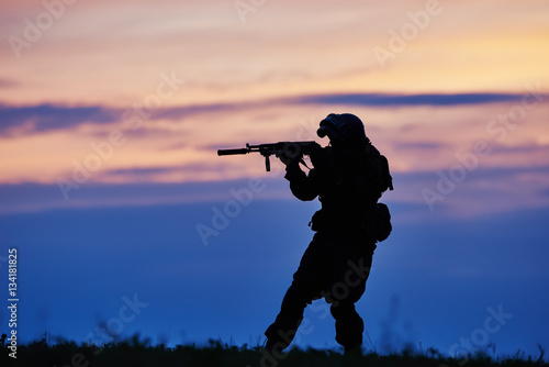 Military soldier silhouette with machine gun