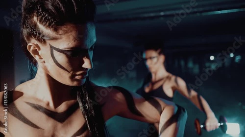 Wallpaper Mural Two young athletes, muscular women training in the gym with weights close up Torontodigital.ca