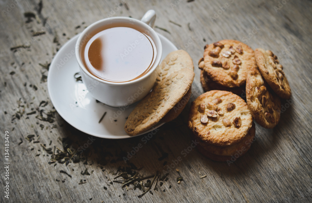 Tea cup and cookies on the desk Tea cup and cookies on the desk