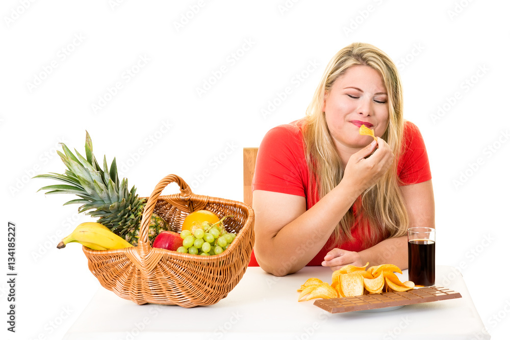 Unhealthy woman eating junk food rather than fruit. Unhealthy woman eating junk food rather than fruit.
