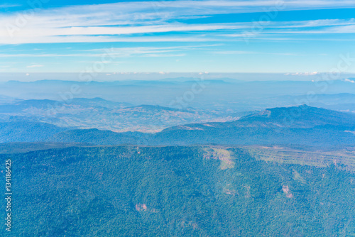 Mountains under clouds. View from the airplane .