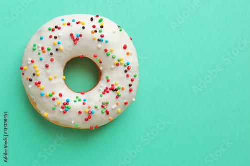 Delicious donut on color background