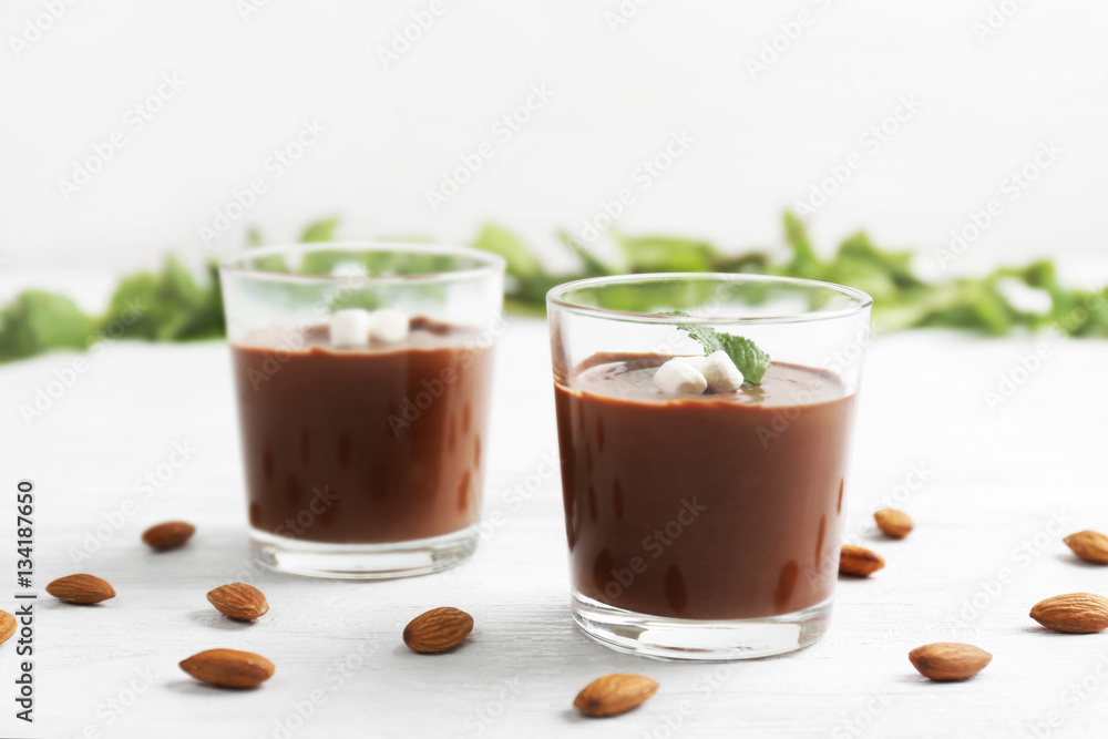 Chocolate mousse with marshmallows in portion glasses on wooden background Chocolate mousse with marshmallows in portion glasses on wooden background