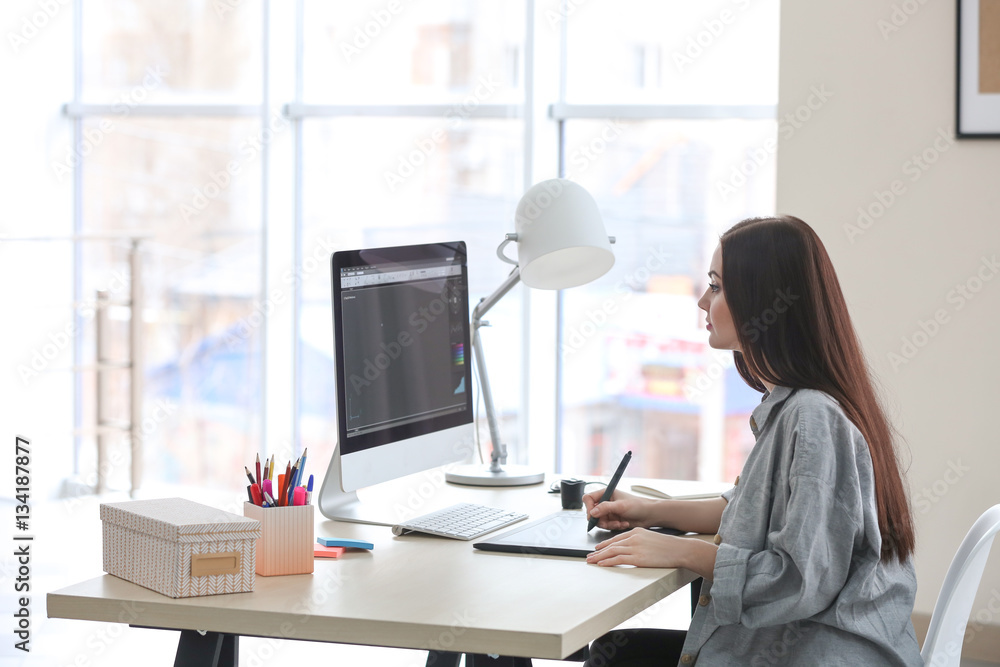 Young female designer working in office Young female designer working in office