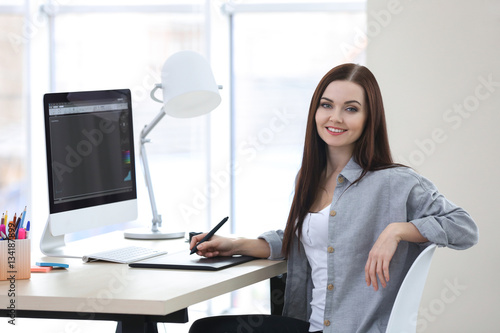 Young female designer worki...