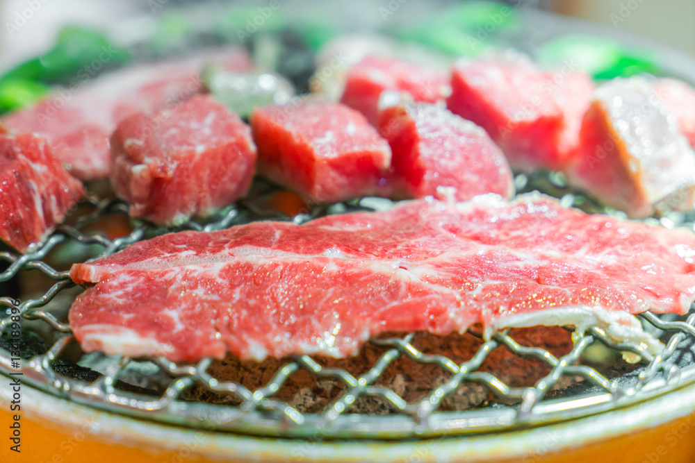 Japanese style Raw fresh beef on hot barbecue grill . Japanese style Raw fresh beef on hot barbecue grill .