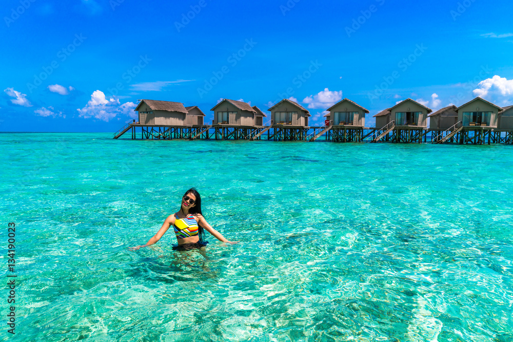 Portrait of happy young woman at beautiful water villa at Maldiv Portrait of happy young woman at beautiful water villa at Maldiv