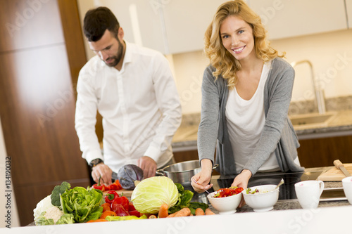 Young couple preparing meal in the kitchen