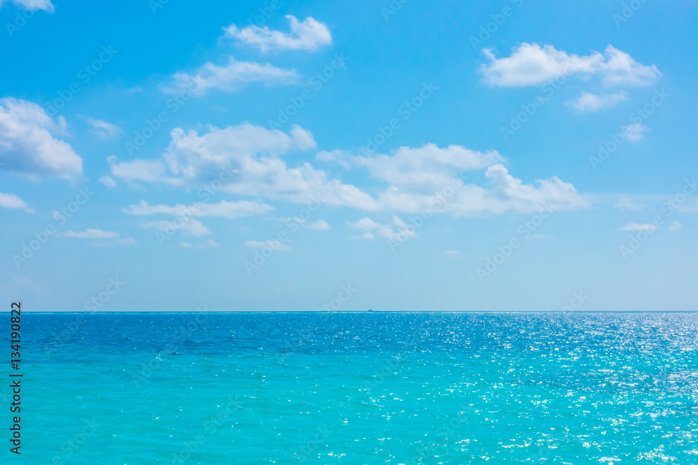 White clouds with blue sky over calm sea in tropical Maldives i White clouds with blue sky over calm sea in tropical Maldives i