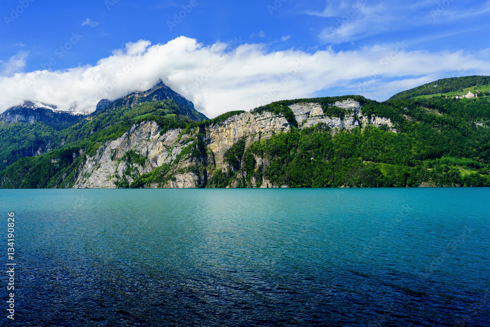 Lake with Mountain and white cloud on sky from Switzerland