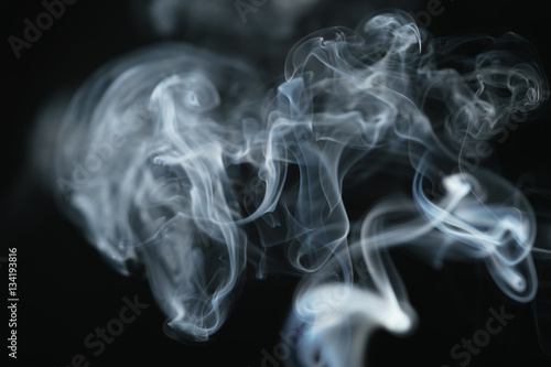 mystery dense blue smoke over dark background, abstract photo