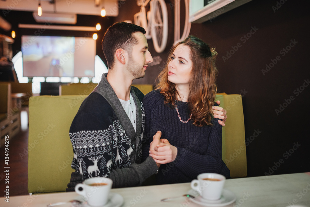 Couple in love. Romantic date of couple in love in cafe. Happy couple enjoying romantic moment in cafe. Love story.