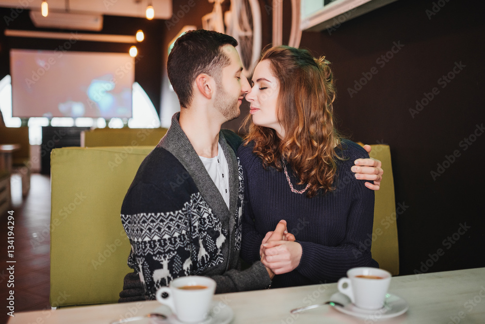 Couple in love. Romantic date of couple in love in cafe. Happy couple enjoying romantic moment in cafe. Love story.