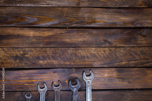 Set various wrenches on wooden background