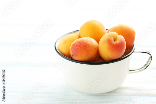 Ripe apricots fruit on white wooden table