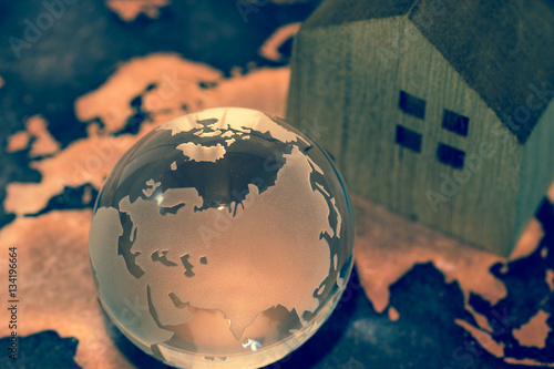 Crystal Globe with House on Grunge World Map
