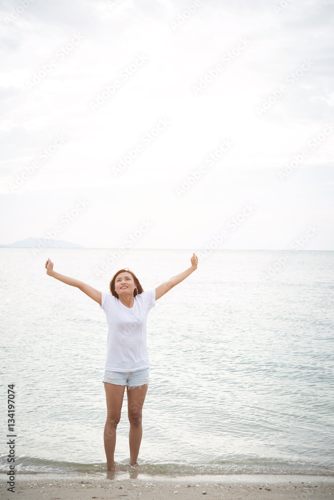 Young beautiful woman standing stretch her arms in the air on th