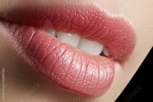 Sweet kiss. Perfect natural lip makeup. Close up macro photo with beautiful female mouth. Plump full lips