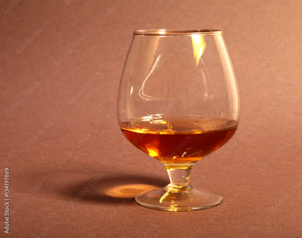 White cup of coffee and cognac in a glasses, pralines on red background. White cup of coffee and cognac in a glasses, pralines on red background.