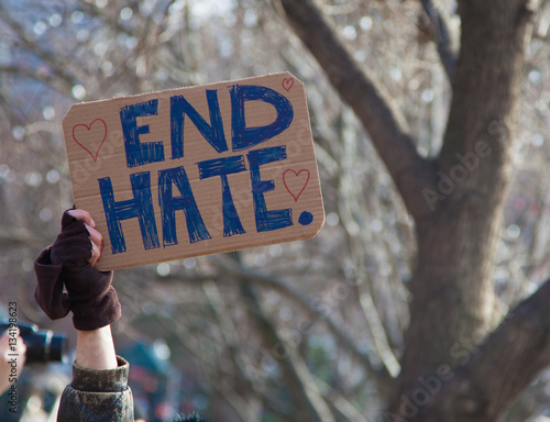 Hand holding sign saying 