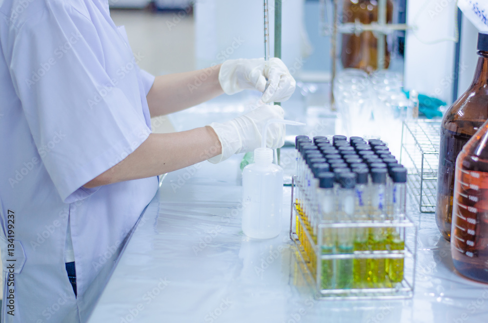 Scientist hand titration at laboratory, titrate chemical, titration with burette and erlenmeyer