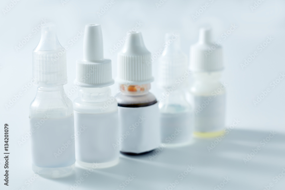 Nasal spray and dropper isolated on white background. Bottles of eye drops, remedy for the common cold isolated on white background. Nasal spray and dropper isolated on white background. Bottles of eye drops, remedy for the common cold isolated on white background.