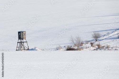 winter frozen landscape with hunting tower on highland