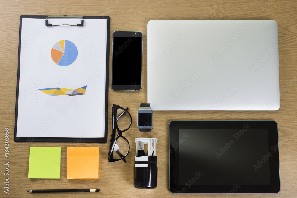 Flat lay image of hipster office desk table with laptop, smartphone, gadgets and supplies. Top view. Flat lay image of hipster office desk table with laptop, smartphone, gadgets and supplies. Top view.
