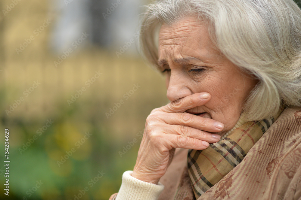 Sad elderly woman in autumn park Sad elderly woman in autumn park