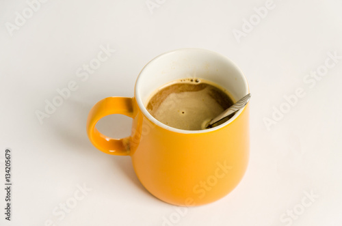 Orange coffee mug  on a white background.
