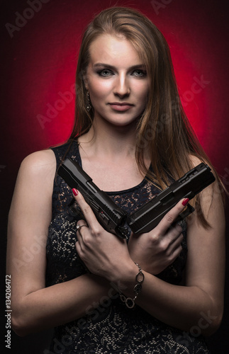 Woman holding two handguns