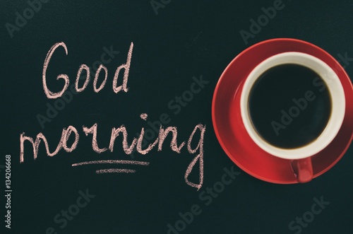 Cup of Coffee on a Dark Background and the Inscription Good Morning.